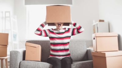 Woman with a moving box on her head.