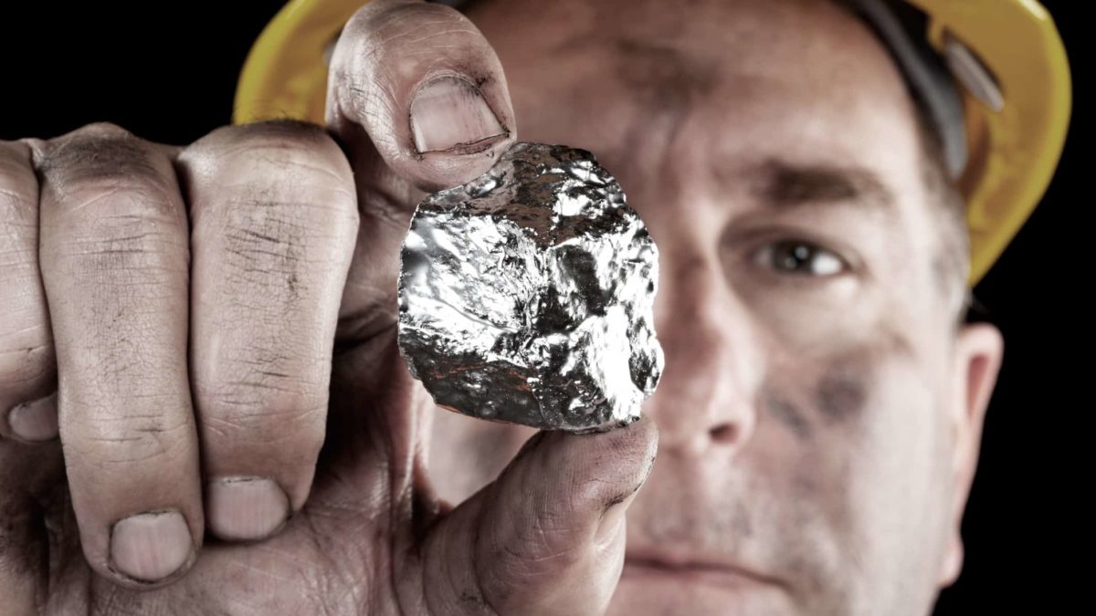 Miner holding a silver nugget