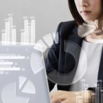 ASX share price on watch represented by woman investor looking at ASX financial results on laptop