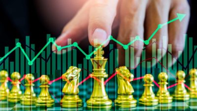 Share investor with chess pieces deciding to buy or sell ASX shares