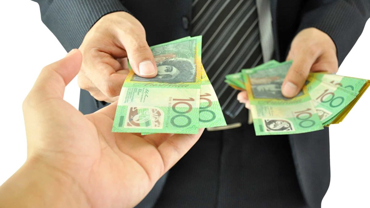 Man handing over cash to another, first investment, asx shares