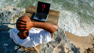 man on beach looking at laptop screen with question mark, why invest, asx 200 shares
