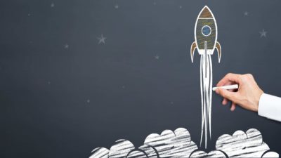 Chalk-drawn rocket shown blasting off into space