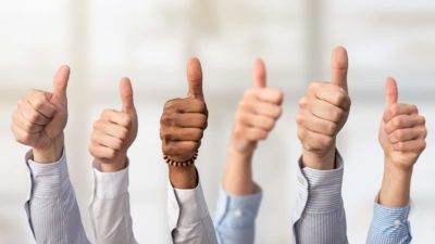 group of hands all giving thumbs up gesture