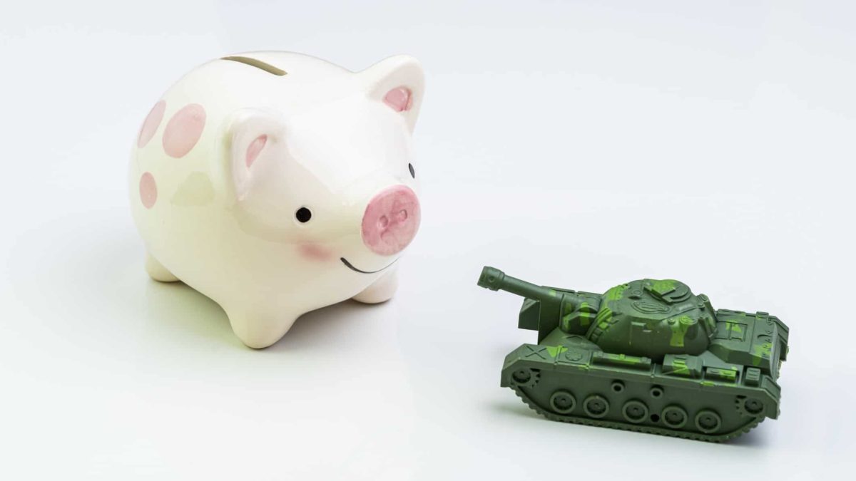 piggy bank next to miniature army tank