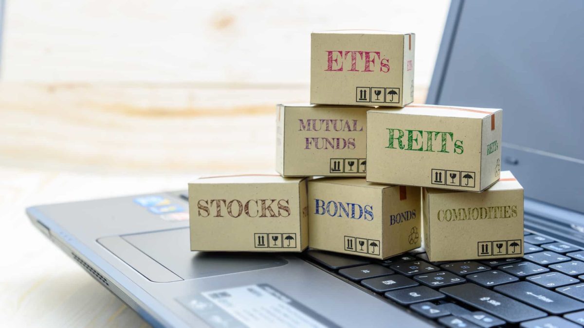 Little boxes entitled ETFs, stocks, REITs and bonds sitting on laptop keyboard