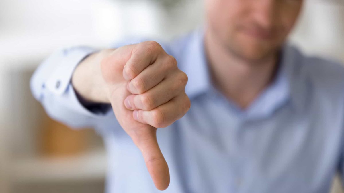 man making thumbs down gesture representing IPH share price