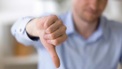 man making thumbs down gesture representing IPH share price