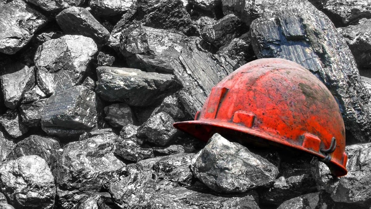 China price control coal miner's hard hat on pile of coal MGA Thermal ASX coal stocks