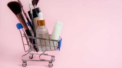 miniature shopping trolley filled with cosmetic items