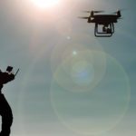 flying asx share price represented by man flying remote control drone