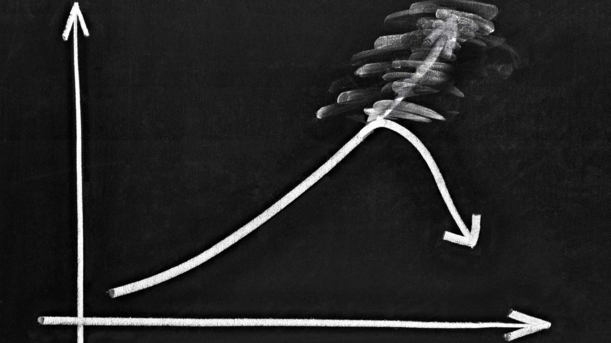chalk drawing of line chart with falling arrow