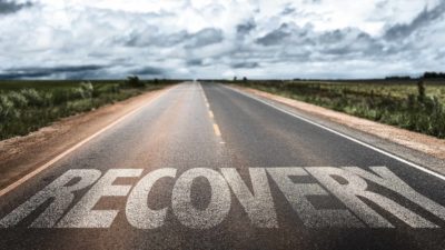 road in the country with word recovery printed on it