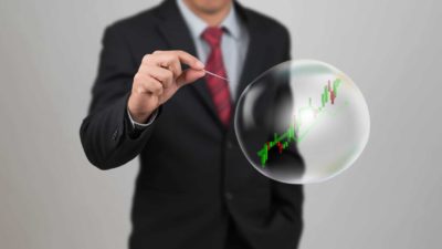 Investor pricking share market bubble