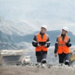 Two workers walking through a silver mine