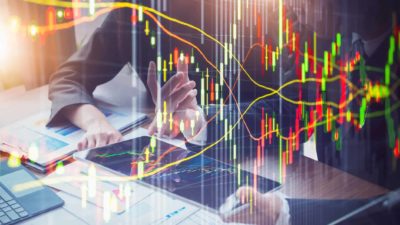 Image of fund managers on laptops with share price chart overlaid