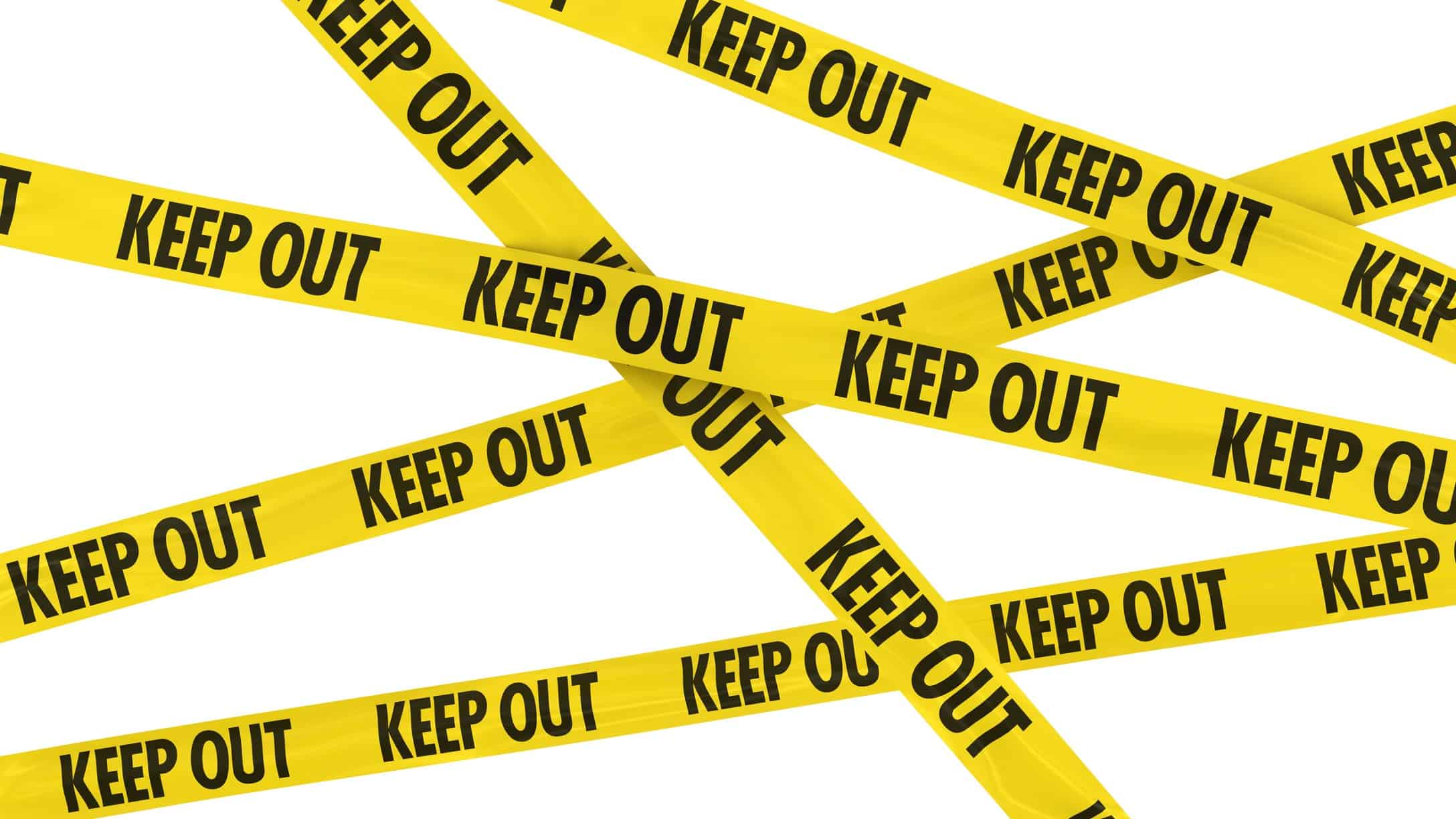 hazard tape stating 'keep out' representing volatility of bank shares