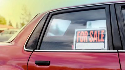 car window with for sale sign in it representing carsales share price