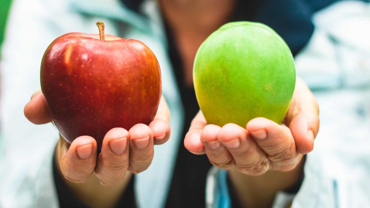 Hands holding out two apples representing choice between different shares
