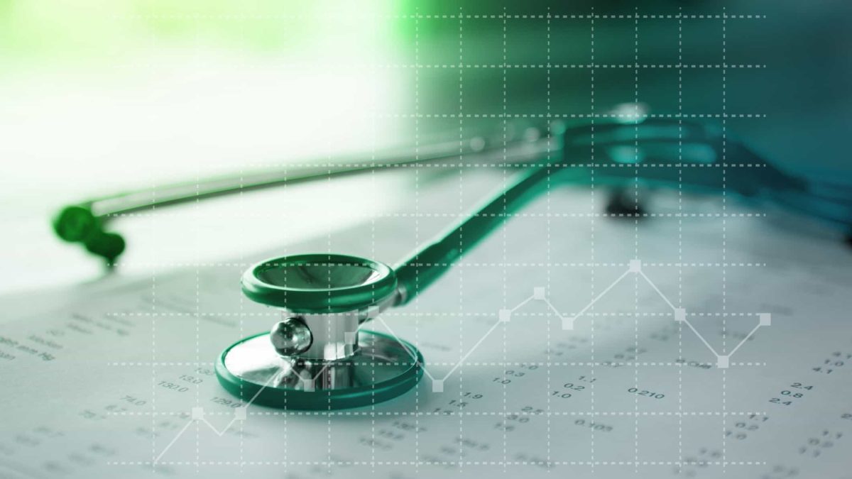 stethoscope on paperwork overlaid with financial chart representing healthcare share