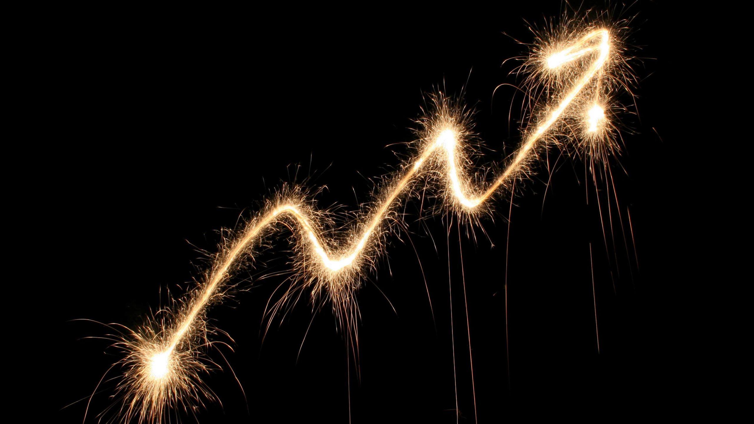 upward trending arrow made from fireworks display