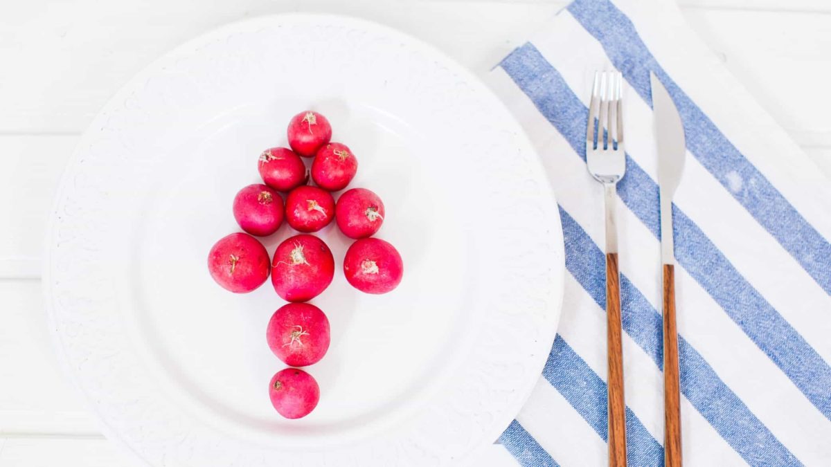 radishes arranged on a dinner plate to form arrow pointing up