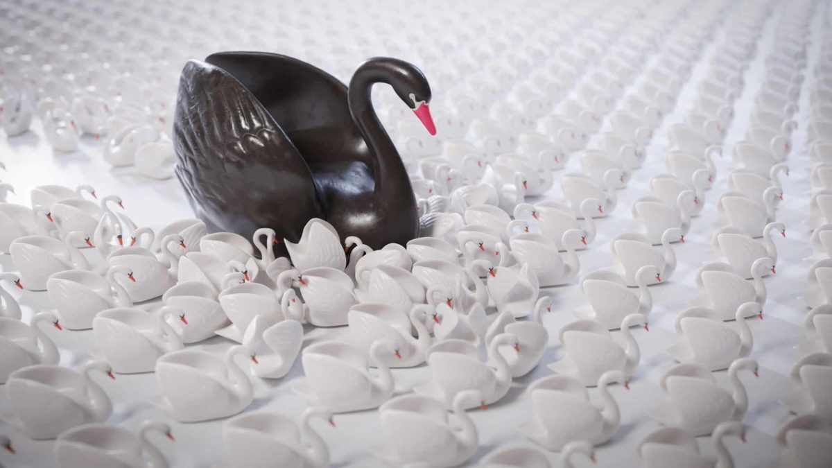 figurine of large black swan among small white swans representing stock market crash