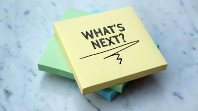 note pad with the words 'what's next' written on it representing uncertainty surrounding mcmillan share price