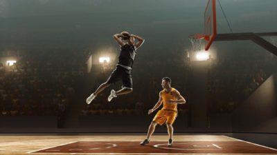 basketball player jumping high to take a shot for goal