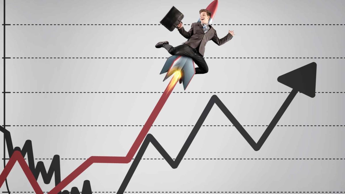 businessman riding rocket on line graph