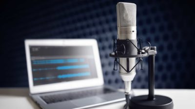 radio microphone next to laptop computer representing Southern Cross share price