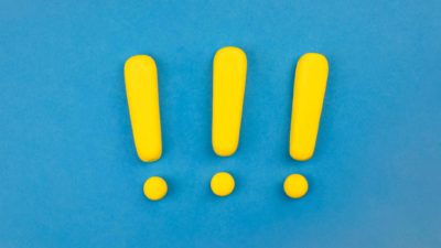 three yellow exclamation marks on blue background