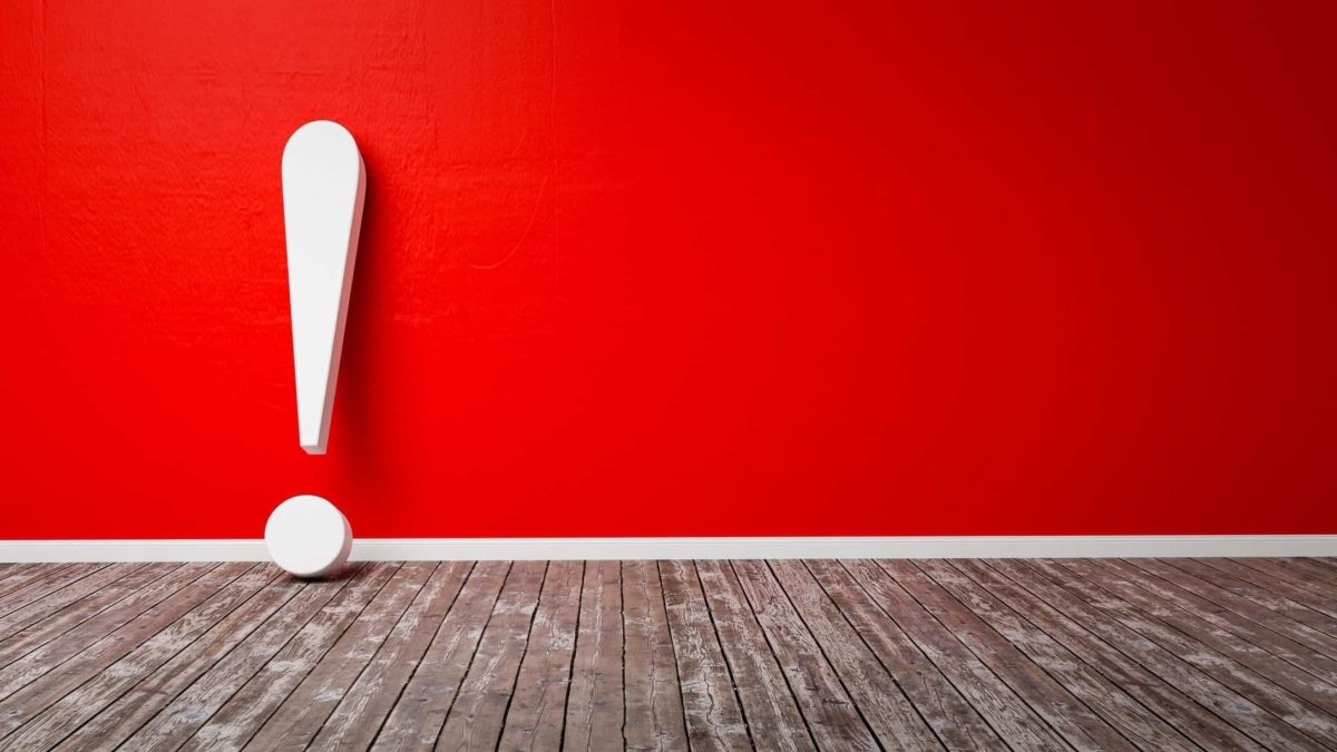 Red wall with large white exclamation mark leaning against it