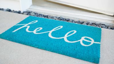Blue welcome mat with 'hello' written on it