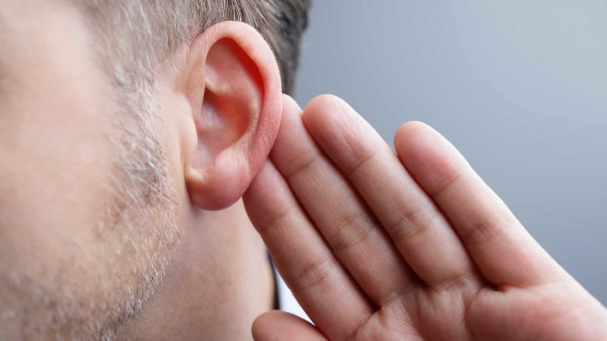 man holding his ear as if listening to what the asx 200 is telling us
