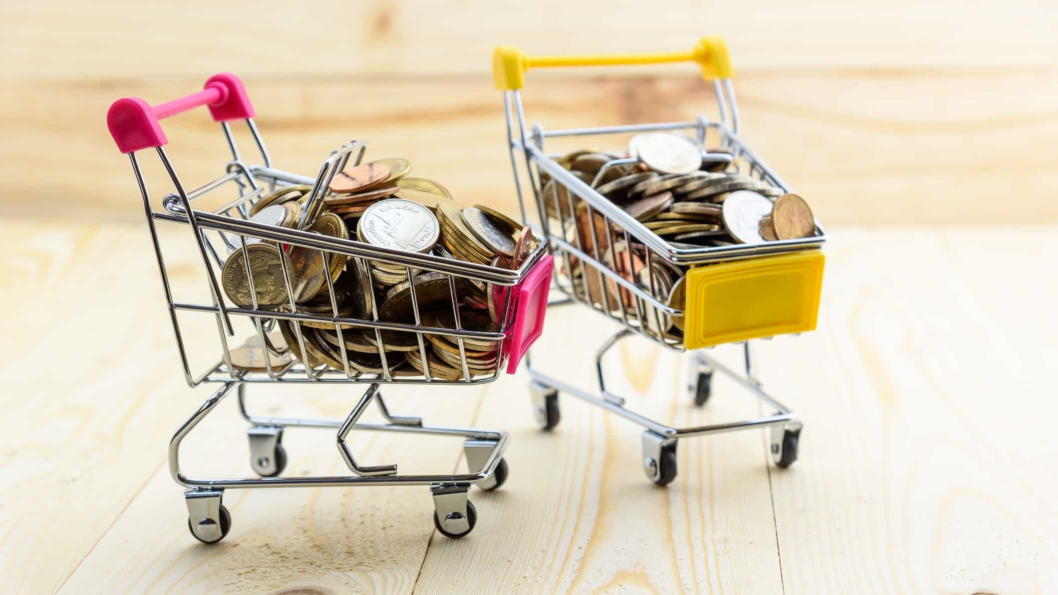 Two miniature shopping trollies filled with coins representing retail ASX growth shares