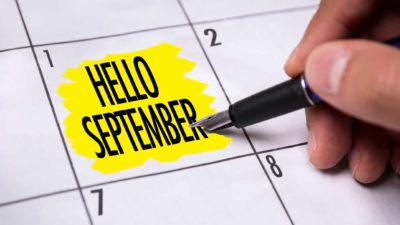 hand pointing pen to date on calendar that says hello september signifying time to buy asx shares