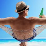 man sitting in hammock on beach representing asx shares to buy for retirement