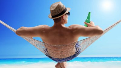 man sitting in hammock on beach representing asx shares to buy for retirement