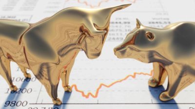 ASX gold inflation gold bull figurine standing on stock price charts representing rising asx share price