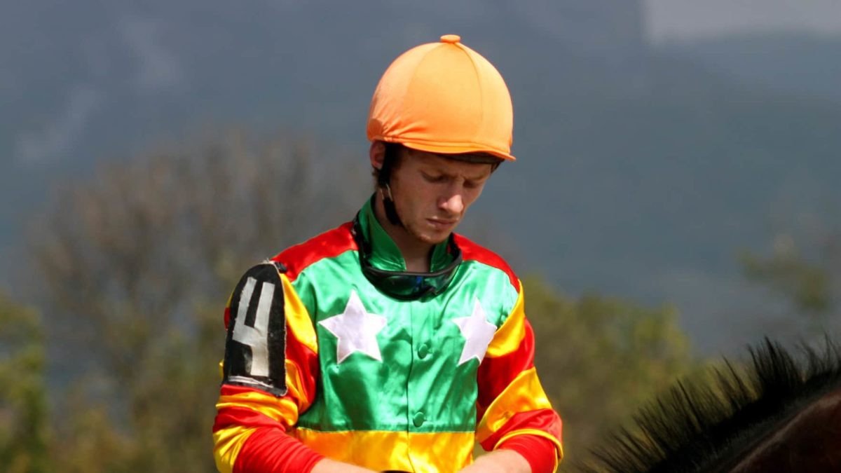 sad looking racing jockey representing falling betmakers share price