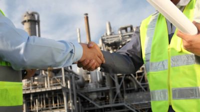 two miners on site shaking hands representing bhp share price