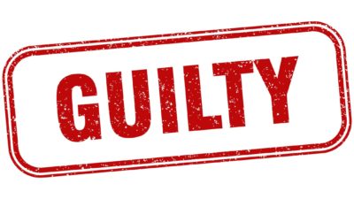 red sign stating 'guilty' representing guilty plea from Bluescope exec