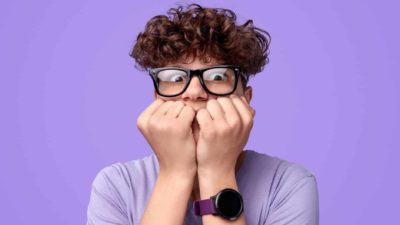 Young man looking afraid representing ASX shares investor scared of market crash