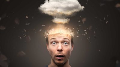 A man looks stunned as a cloud explodes from his head representing the CogState share price crashing today in