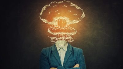 A cloud of explosion appears in place of a man's head.