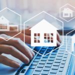 Graphics of houses with a person typing on a laptop.