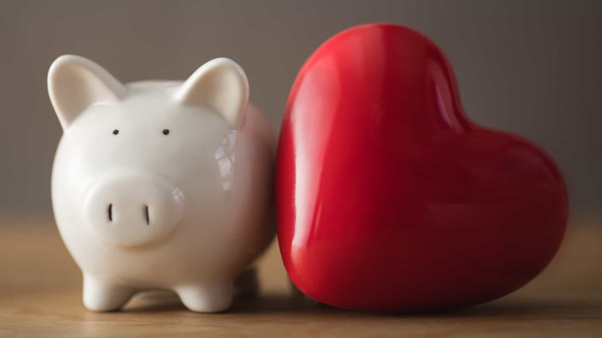 piggy bank next to big red heart representing osprey share price
