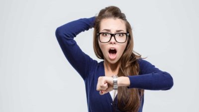 woman looking shocked at the watch on her wrist representing whether it is too late to buy the whisper share price