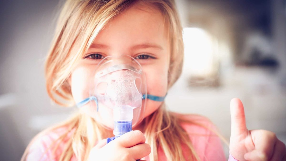 little girl giving thumbs up whilst using asthma inhaler representing respiri share price